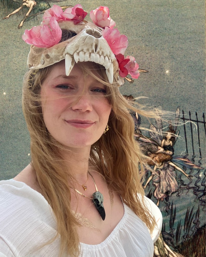A photo of author Gabriela Houston, wearing a flower-embellished skull crown